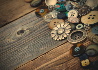 buttons in large numbers scattered on aged wooden boards