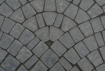 Background. Texture. Stone paved road. Top view close-up
