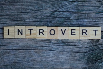 word introvert of brown wooden letters on a gray table