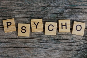 Fototapeta premium word psycho made of wooden letters lies on a gray blackboard