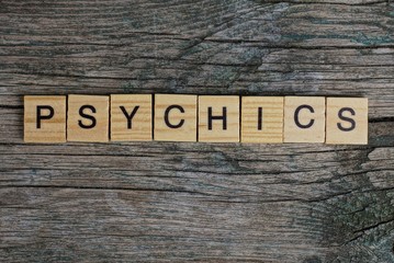 psychics word made of wooden letters on a gray table