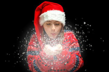 An isolated shot of a woman celebrating christmas and blowing snow