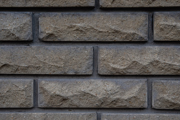Background. Wall lined with facing stone. Close-up