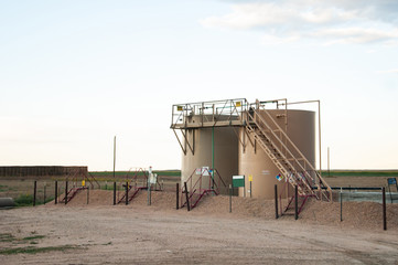 Two tanks used to store crude oil after it is pumped from the ground.
