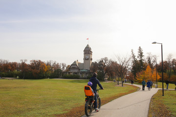 Winnipeg, Manitoba / Canada - October 20, 2019: Dad and Son Cycling at Assiniboine Park.