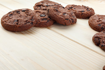 Tasty cookies with chocolate chips placed on a wooden background . Selective focus shot.