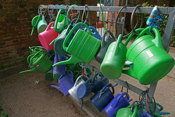 Colorful watering pots in blue and green