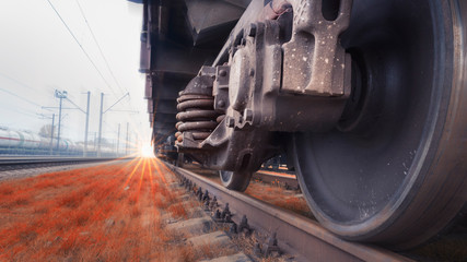 Bottom View of the wheels of a train traveling fast by rail. Fast cargo delivery by train. Blurred...