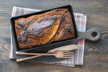 Homemade banana bread with cinnamon on a wooden background, close up, top view