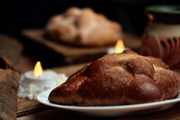 Bread of the dead, Mexican traditions days of the dead, traditional bread in the background sweet bread and a jar with coffee, all on wooden logs.