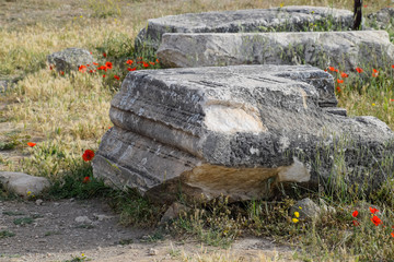Fragments of ancient buildings, ruins of the ancient city of Hierapolis. Stone blocks with traces of stone machining.