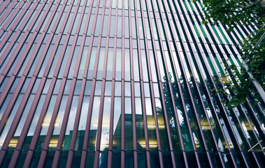 Background of glass windows with metal lines. Detail of the facade of the office building.