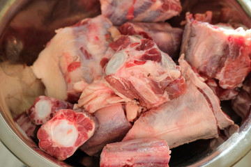 Cutted oxtail in a bowl. Raw meat