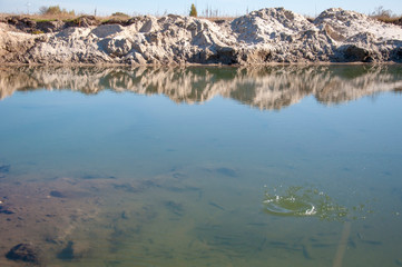 Splashes and circles on the water from an abandoned stone