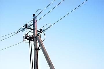 high-voltage power lines against the clear sky