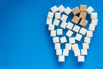 the carious tooth of sugar cubes of refined sugar, preventing tooth decay, caring for the health of your teeth, the causes of caries
