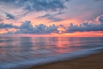 Naklejka na ściany i meble Phuket beach sunset, colorful cloudy twilight sky reflecting on the sand gazing at the Indian Ocean, Thailand, Asia.