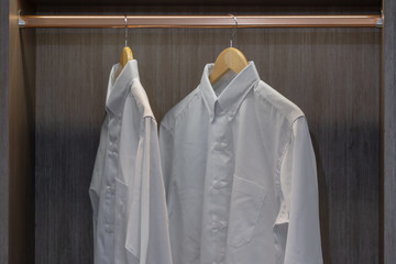 Men shirt hang in a wooden closet at modern home
