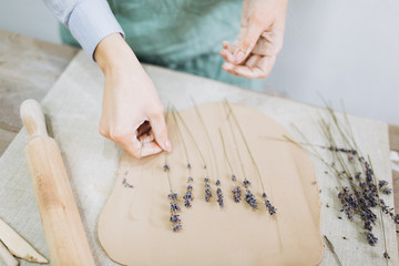 The potter's hands are shaped a cup from a clay. The process of creating pottery. The master ceramist works in his studio. Close-up, only hands. Crockery from clay own hands.