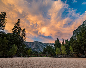 Amazing pink sunset at Yosemite National park looking towards the swinging bridge over the Merced...