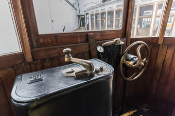 metal control lever in an old tram. control panel inside old funicular railway tram with curved wooden handle