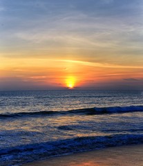 Obraz premium Phuket beach sunset, colorful cloudy twilight sky reflecting on the sand gazing at the Indian Ocean, Thailand, Asia.