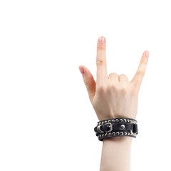 hand with leather rocker bracelet with rock and roll sign, rock music isolated on white background