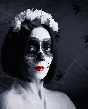 Young beautiful girl with traditional mexican death mask. Calavera Catrina. Sugar skull makeup