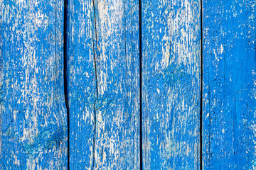background wooden old fence made of boards, blue, shabby paint, aged texture