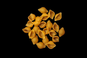 pasta unprepared raw conchiglie rigate shells of durum wheat handmade isolated on black background