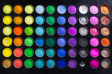 Close-up of colorful makeup background, eyeshadow palettes.