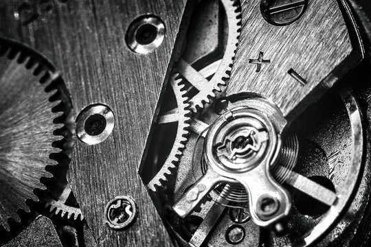 vintage old mechanism with gears and springs, clock mechanism close-up macro, black and white photo