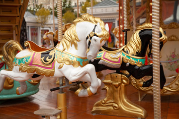 Old carousel with horses in a holiday autumn evening park with nobody