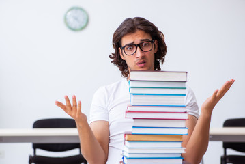 Young male student sitting in the classroom