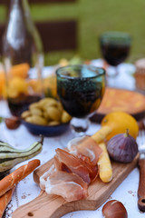 Table prepared for lunch in autumn nature, picnic . Harvest, autumn lunch, Wine and glasses. Outdoor meeting.