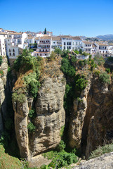 Beautiful city of ronda, Spain. Old buildings in the edge of the canyon and puento nuevo bridge.