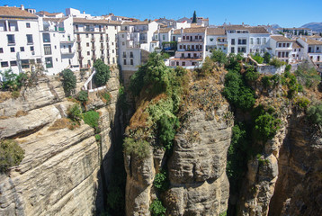 Beautiful city of ronda, Spain. Old buildings in the edge of the canyon and puento nuevo bridge.