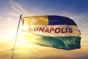 Eunapolis of Brazil flag waving on the top sunrise mist fog