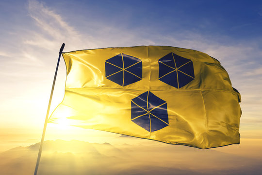 Itabuna of Brazil flag waving on the top sunrise mist fog