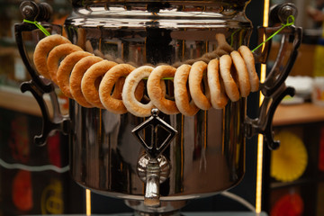 Russian large iron kettle Samovar with a round of dry bread