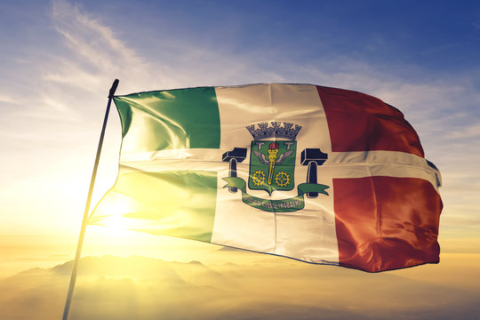 Osasco of Brazil flag waving on the top sunrise mist fog
