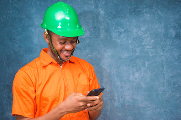 young african engineer got excited with what he  saw on his phone