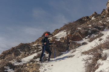 Young hiker climbs a mountain