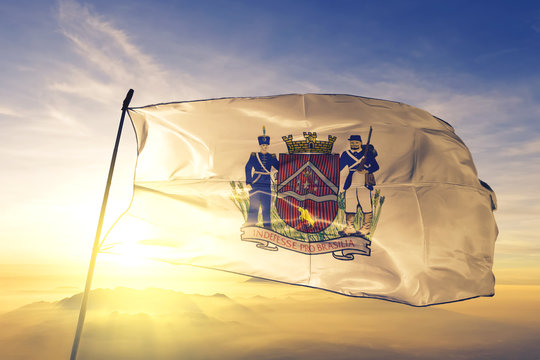 Uberaba of Brazil flag waving on the top sunrise mist fog