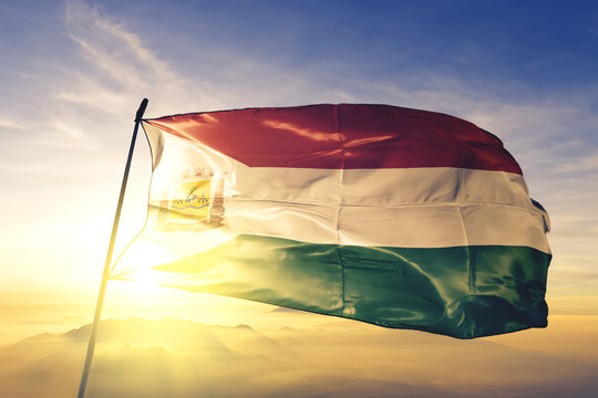 Varzea Grande of Brazil flag waving on the top sunrise mist fog