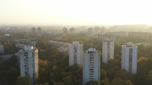 Croatia, city of Zagreb, sunset over residential towers of Novi Zagreb socialist district in autumn day, drone circle footage