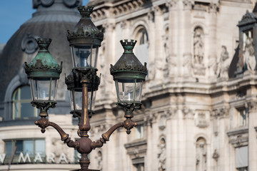Fototapeta na wymiar Ornate street lights with old european building in background