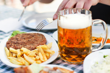 Meal - Burger Fries and Beer Served on the Table