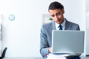 Businessman with heavy paperwork workload