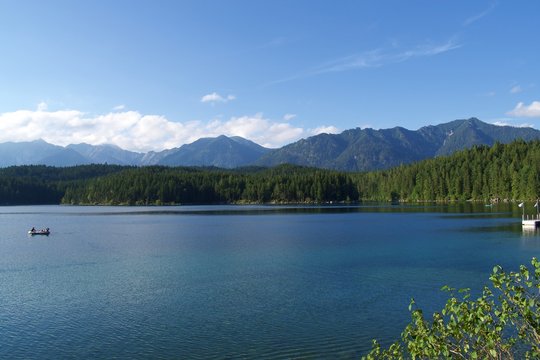 View of Lake Eibsee in Bavaria, Germany, with people in cannoe